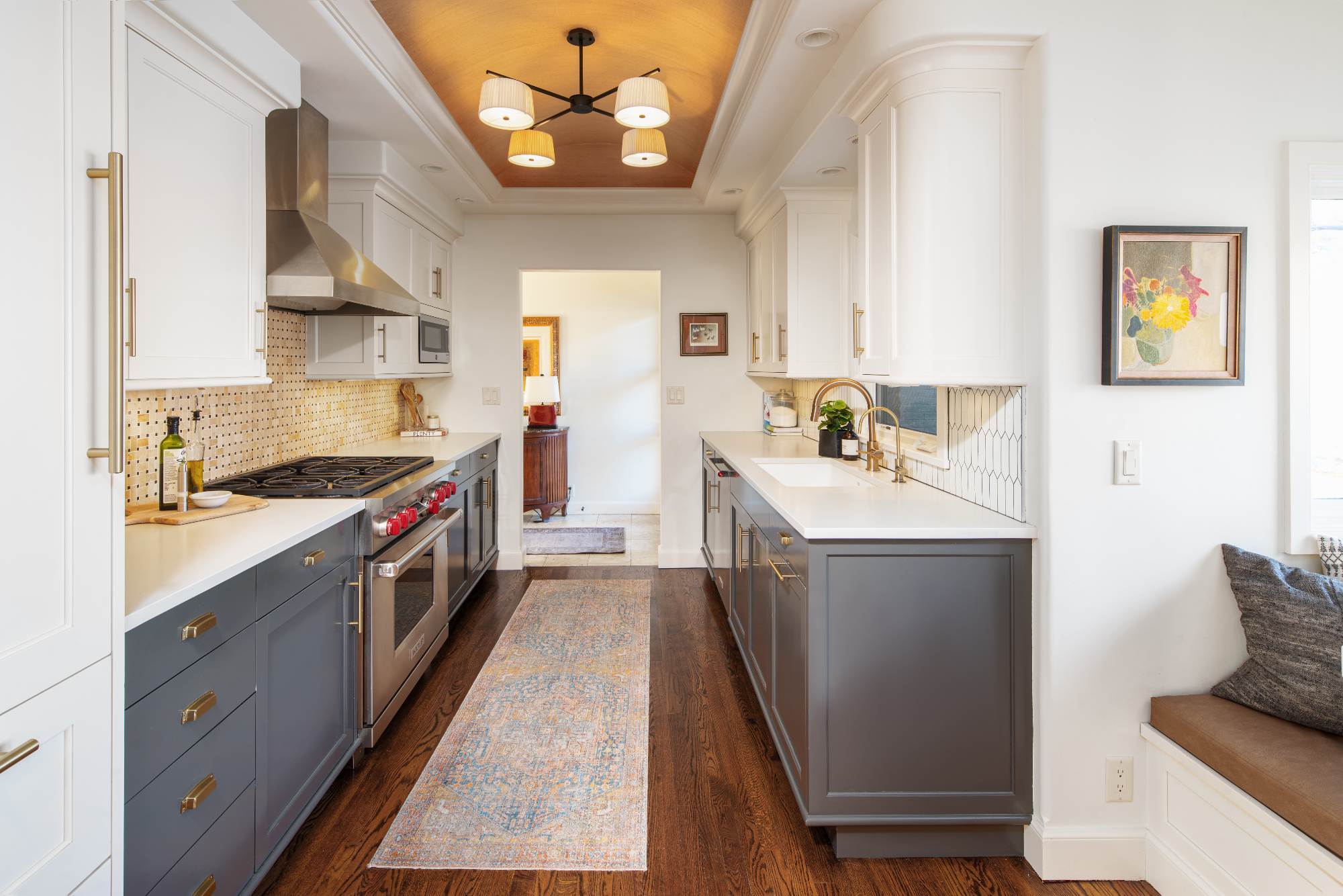 Modern Omaha, NE kitchen renovation by HC Remodel & Design with white upper cabinets, gray lower cabinets, and designer lighting-optimized