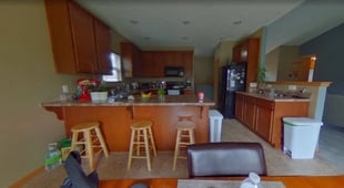 oak-kitchen-peninsula-with-bar-stools-before-remodel