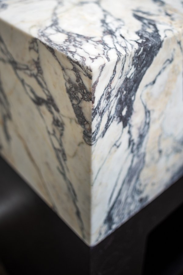 Bathroom remodel by HC Remodel & Design in Omaha, NE featuring a detailed view of the waterfall marble vanity corner with seamle-optimized