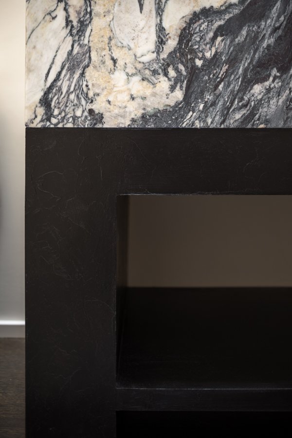 Bathroom remodel by HC Remodel & Design in Omaha, NE featuring the custom black vanity base beneath a marble waterfall counterto-optimized