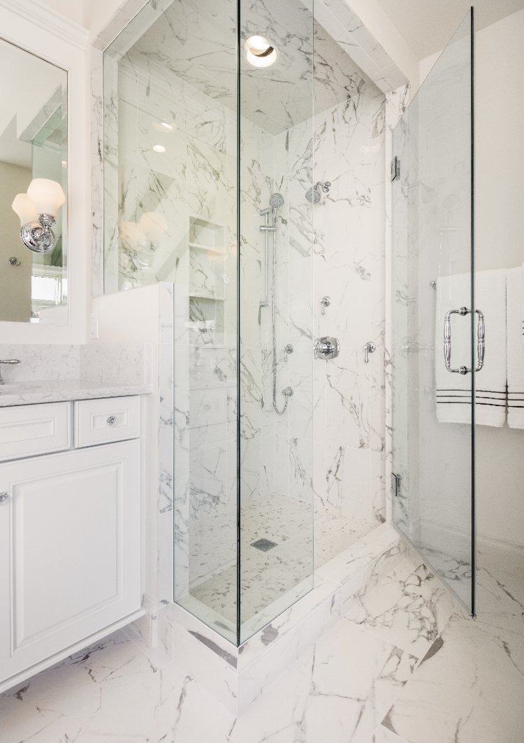 Master bathroom remodel by HC Remodel & Design in Omaha, NE featuring a frameless glass walk-in shower with marble tile walls an-optimized