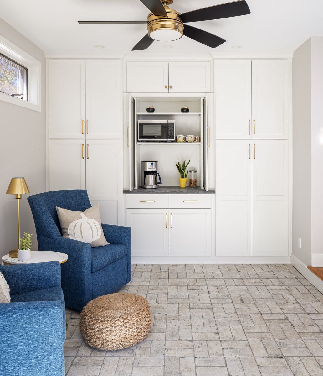 built-in-cabinetry-with-blue-armchair-and-brick-flooring-omaha-ne-optimized