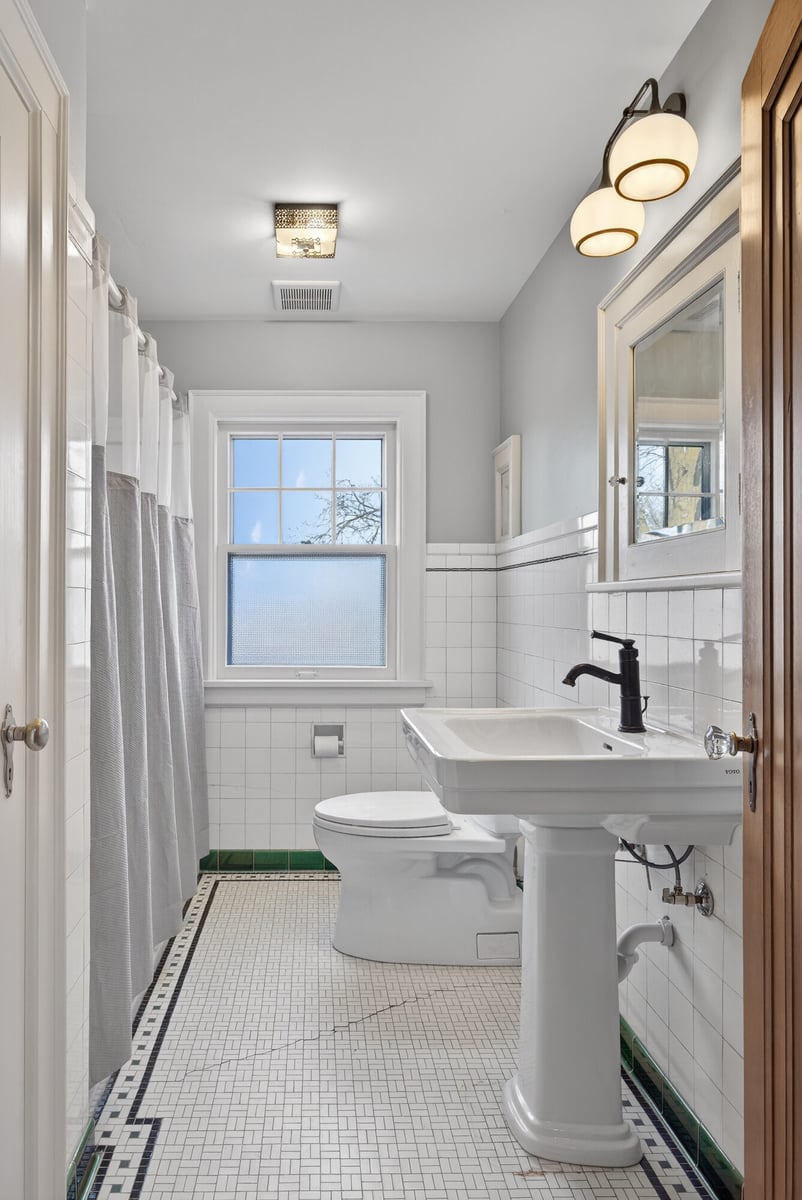 bathroom-with-pedestal-sink-and-mosaic-floor-omaha-ne-optimized
