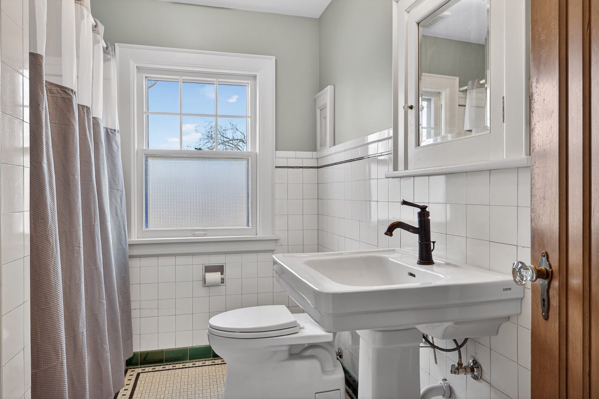 renovated-bathroom-with-pedestal-sink-and-tile-omaha-ne-optimized