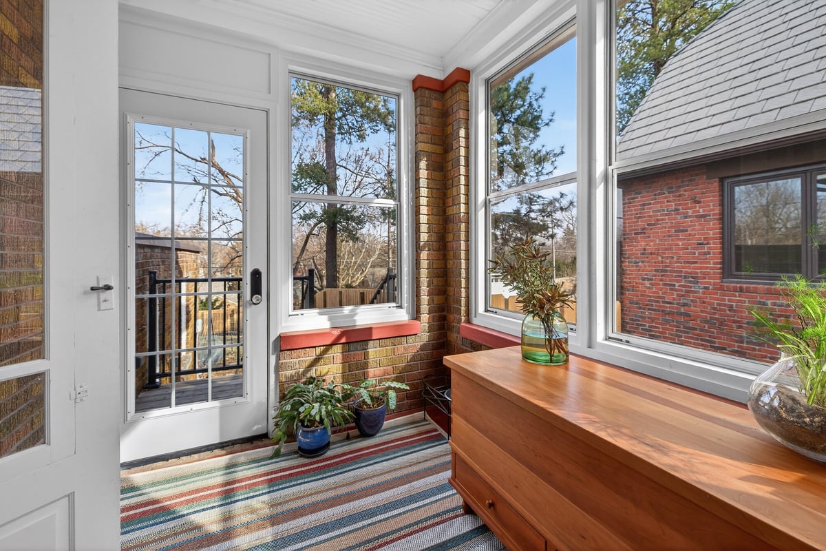 sunroom-with-wall-of-windows-and-wood-bench-omaha-ne-optimized