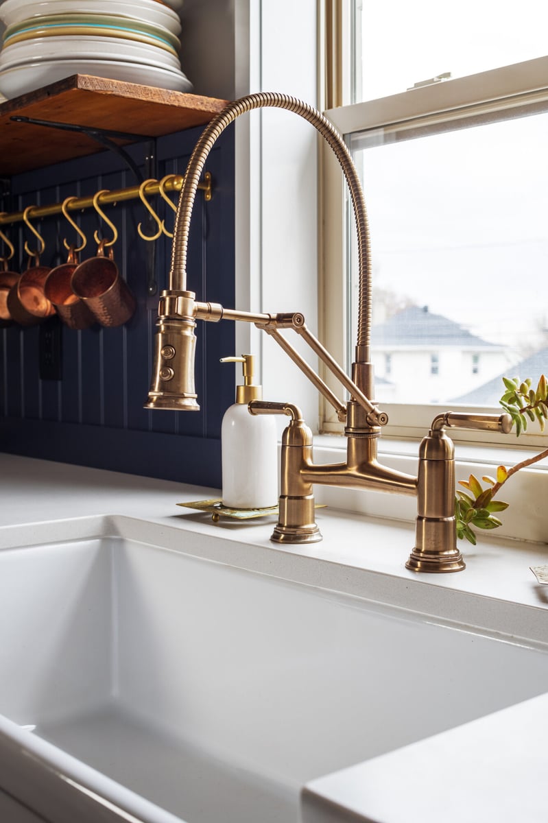 brass-gooseneck-faucet-over-farmhouse-sink-omaha-ne-optimized