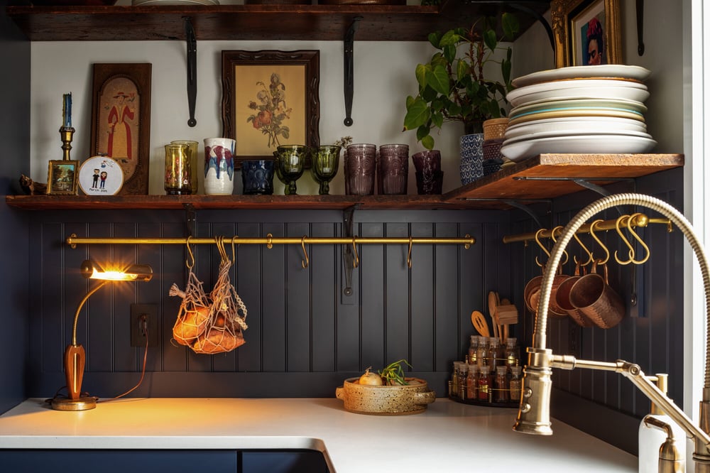 navy-kitchen-open-shelving-with-brass-accents-omaha-ne