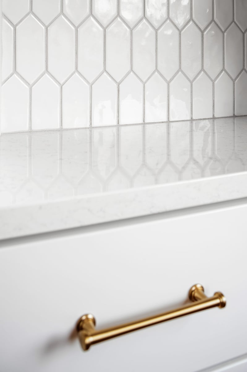 brass-cabinet-pull-detail-on-white-drawer-omaha-ne-optimized