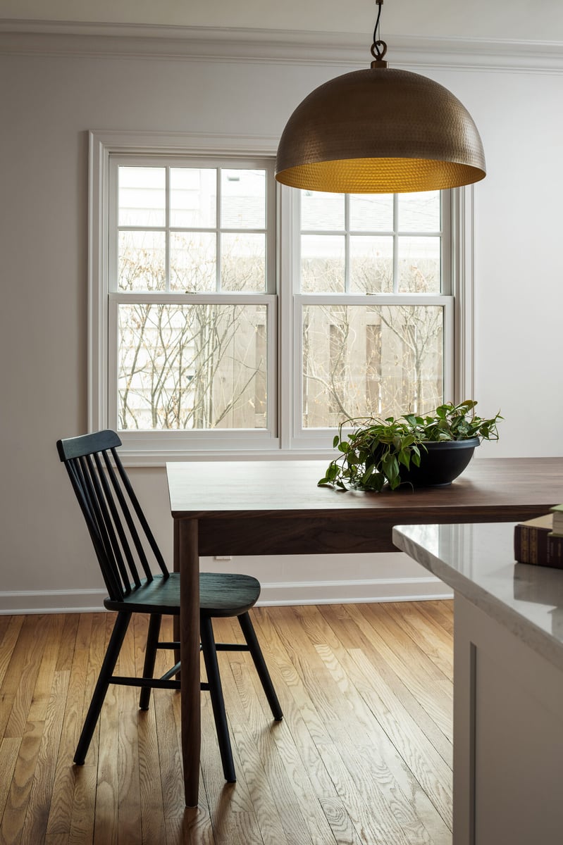 dining-nook-with-wood-table-and-brass-pendant-omaha-ne-optimized