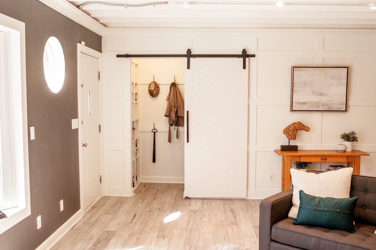 living-room-with-barn-door-and-round-window-omaha-ne-optimized