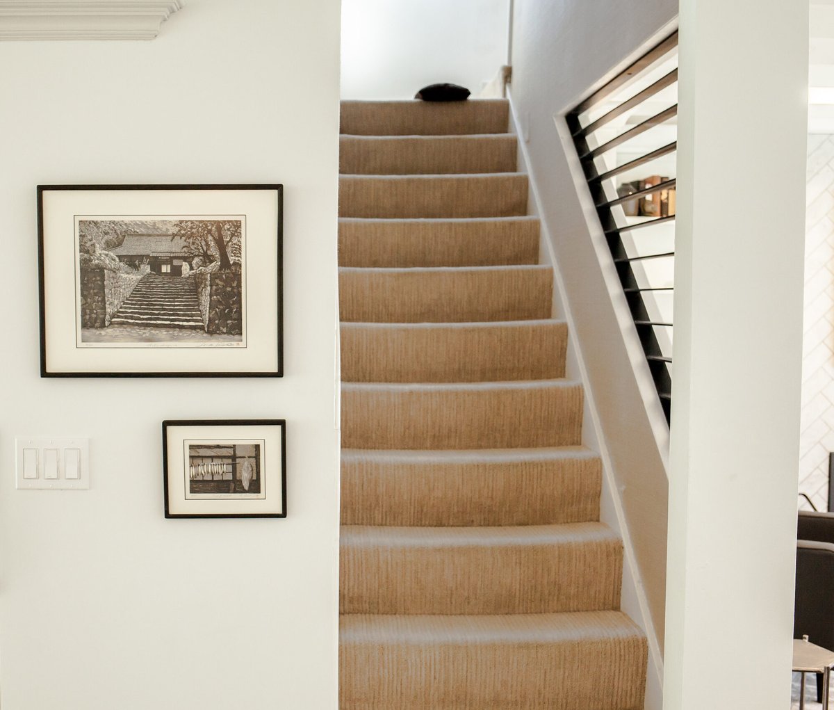 staircase-with-black-railing-and-artwork-omaha-ne-optimized