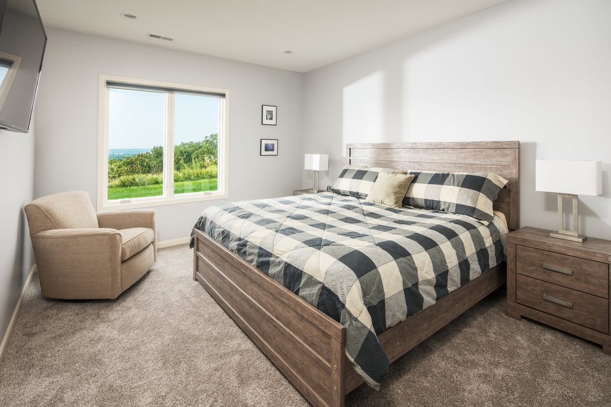 basement-guest-bedroom-with-plaid-bedding-council-bluffs-ia-optimized