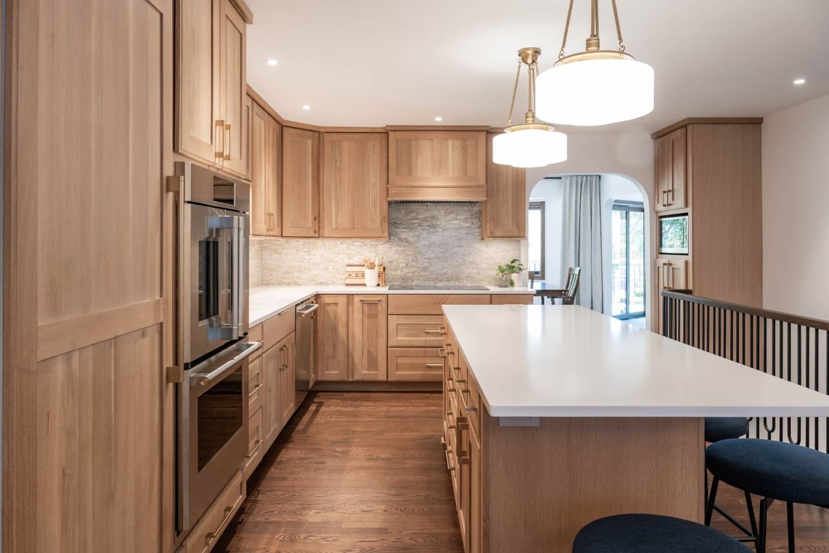 Bright kitchen renovation by HC Remodel & Design in Omaha, NE with custom cabinets, oversized island, and hardwood flooring.-optimized