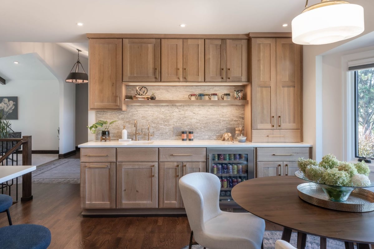 Open kitchen remodel by HC Remodel & Design in Omaha, NE featuring a large quartz island and custom wood cabinetry.-optimized