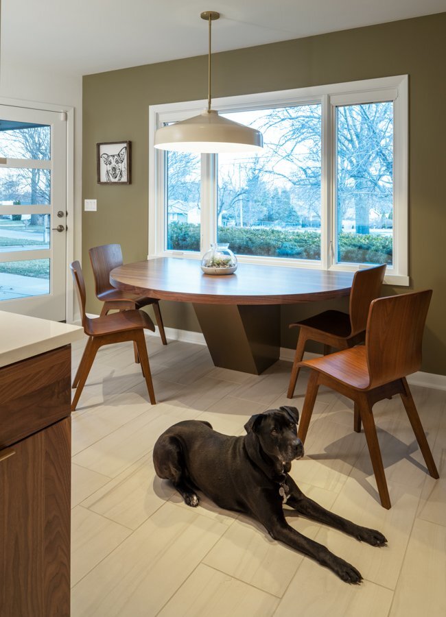Contemporary breakfast area in an Omaha, NE kitchen remodel by HC Remodel & Design with a custom table and expansive windows.-optimized
