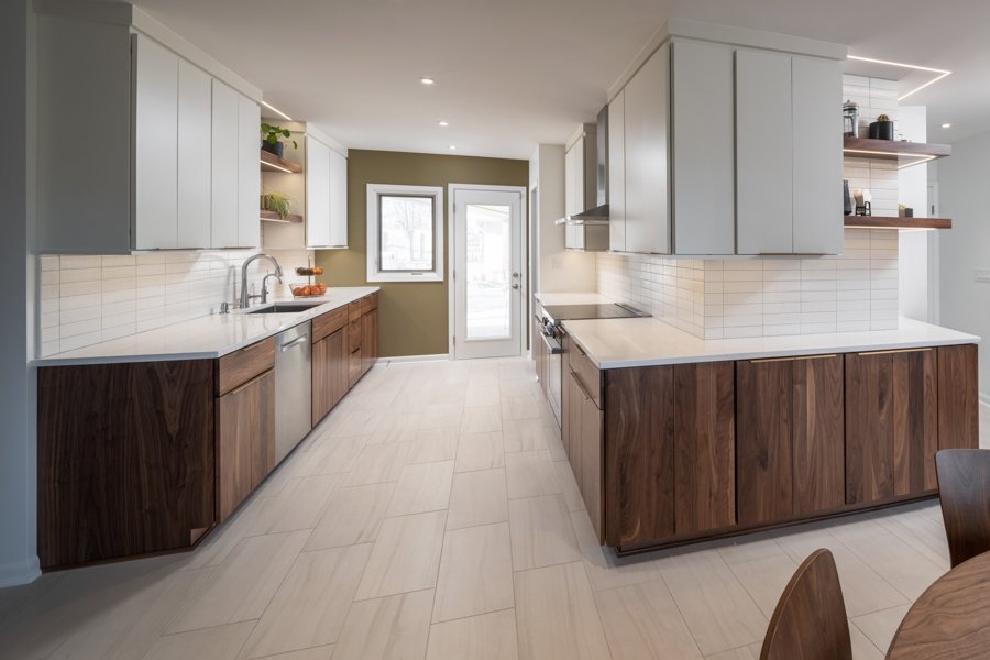 Contemporary kitchen renovation in Omaha, NE by HC Remodel & Design with walnut lower cabinets, white upper cabinets, and an ope-optimized