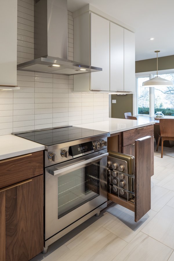 HC Remodel & Design kitchen remodel in Omaha, NE featuring a custom pull-out baking sheet organizer beside the stainless steel r-optimized