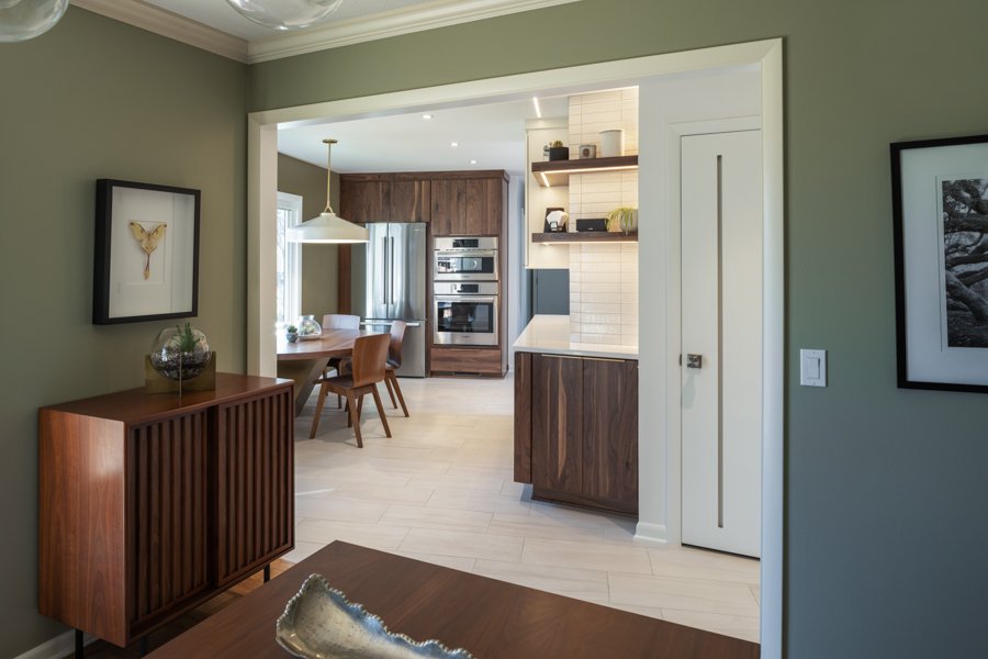HC Remodel & Design kitchen remodel in Omaha, NE featuring a view into the modern kitchen with walnut cabinetry, white finishes,-optimized