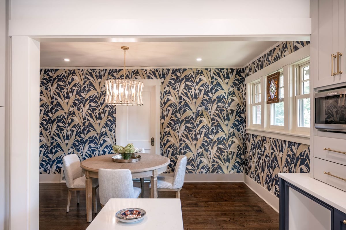Dining room with bold blue botanical wallpaper connected to a custom kitchen remodel by HC Remodel & Design in Omaha, NE.-optimized