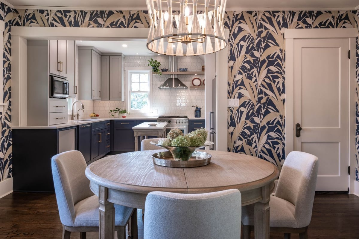 Dining room with botanical wallpaper opening into a custom kitchen remodel by HC Remodel & Design in Omaha, NE.-optimized