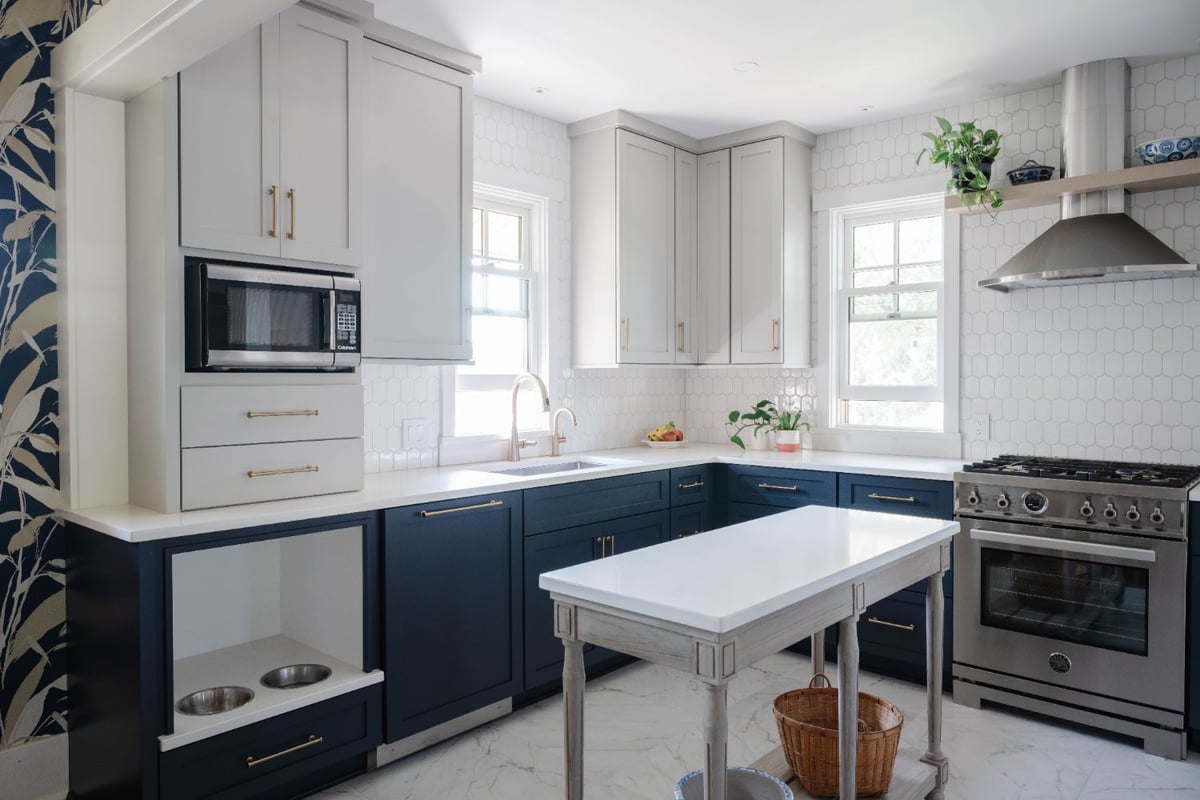 Kitchen remodel by HC Remodel & Design in Omaha, NE featuring navy shaker cabinets, white countertops, and a custom prep island.-optimized