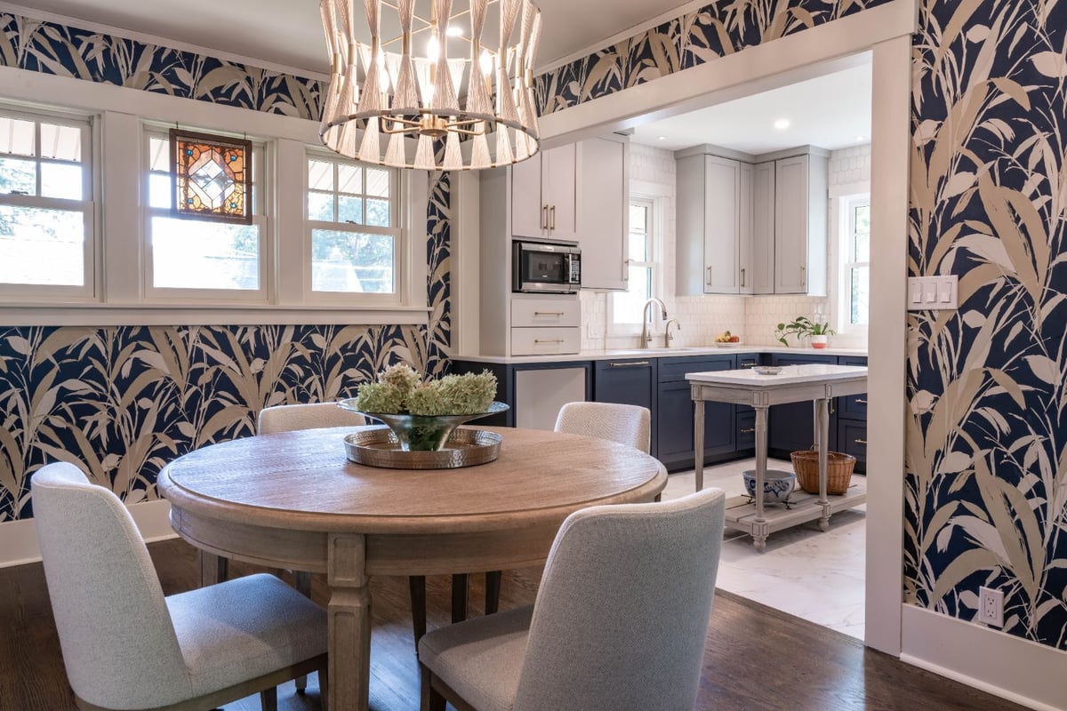 Open dining room and kitchen remodel by HC Remodel & Design in Omaha, NE featuring custom cabinetry, botanical wallpaper, and a -optimized