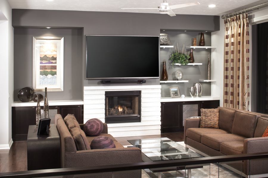 Modern living room remodel by HC Remodel & Design in Omaha, NE with a fireplace, custom built-ins, and wall-mounted TV.-optimized