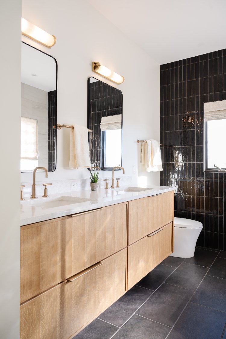 Custom wood double vanity with black accent tile wall in a primary bathroom remodel by HC Remodel & Design in Papillion, NE.-optimized