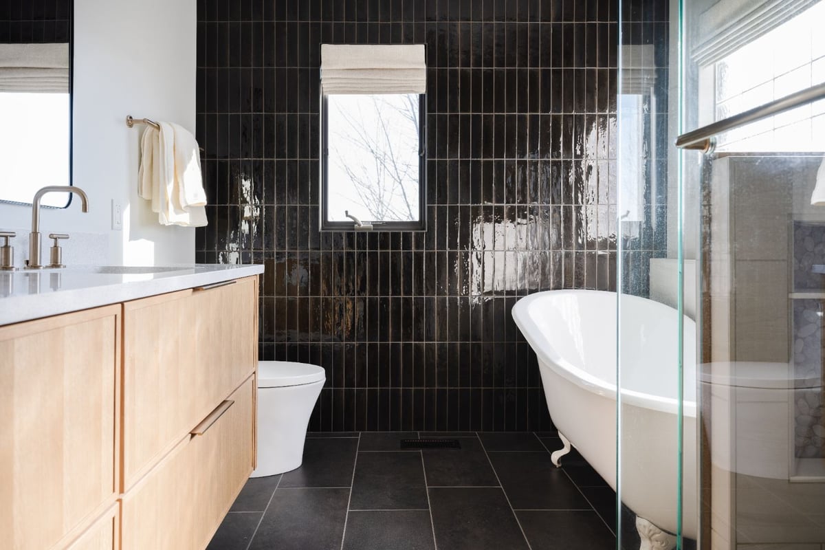 Luxury bathroom remodel with a white oak vanity, glass shower, and freestanding soaking tub by HC Remodel & Design in Papillion,-optimized