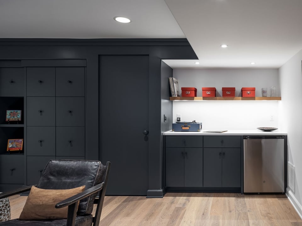 Basement bar area with built-in storage, white countertop, and beverage fridge in Omaha & Council Bluffs.