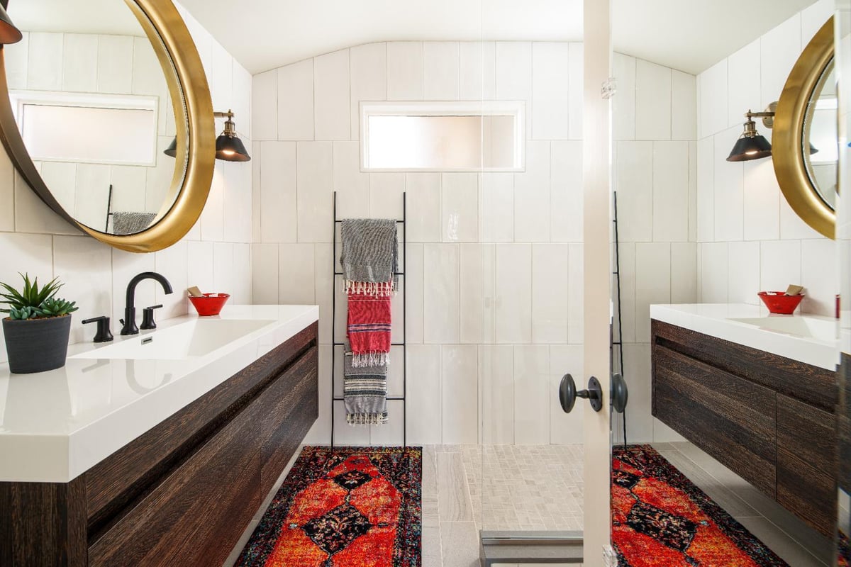 Contemporary Omaha, NE bathroom renovation by HC Remodel & Design with a floating vanity, white tile, and frameless shower glass-optimized