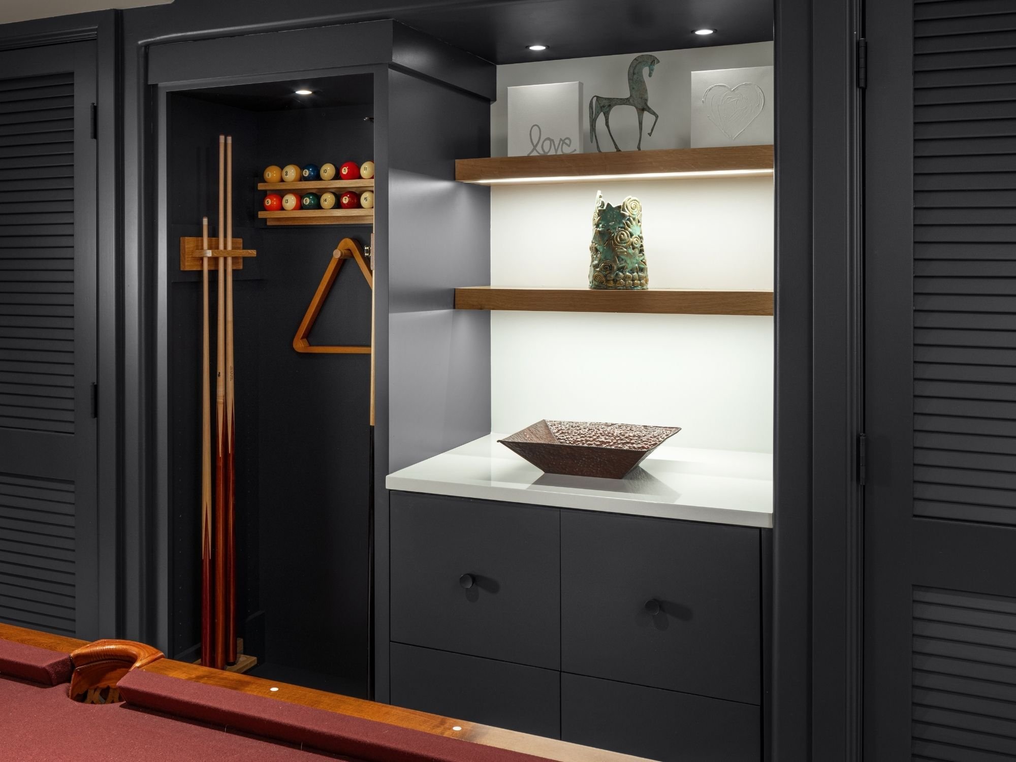 Finished basement game room with built-in shelving, cabinetry, and pool cue storage in Omaha & Council Bluffs - optimized.