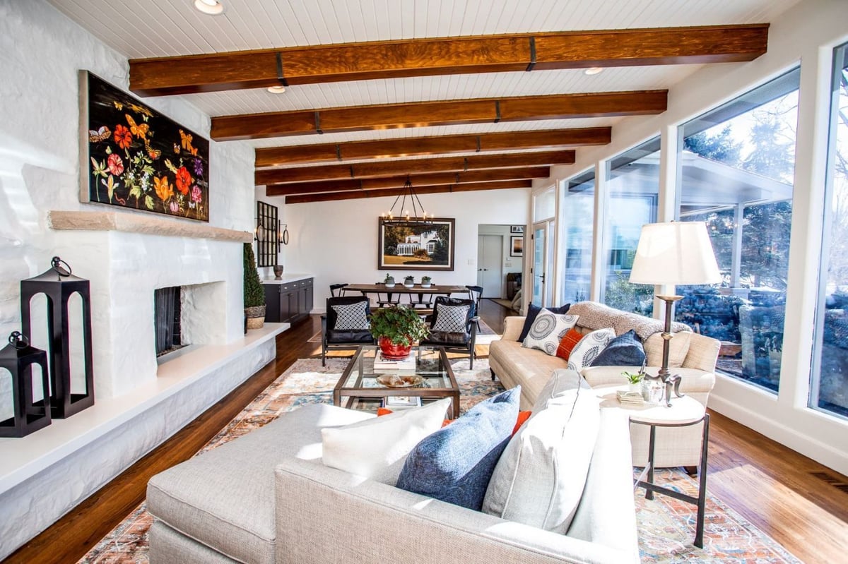 HC Remodel & Design open-concept first floor remodel in Omaha, NE featuring a living room, dining area, exposed beams, and a mod-optimized