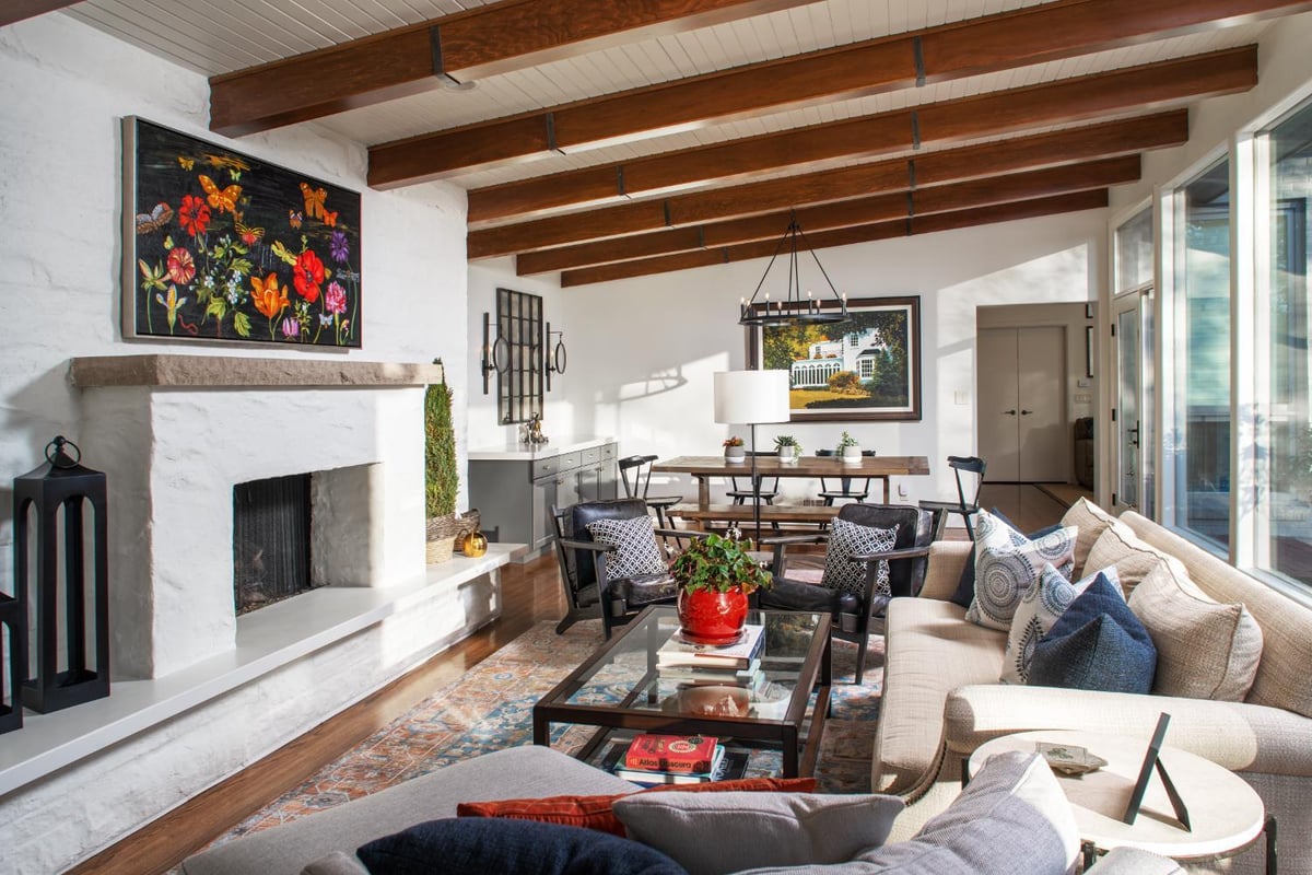Open living space remodel by HC Remodel & Design in Omaha, NE with vaulted ceilings, custom fireplace, and expansive windows.-optimized