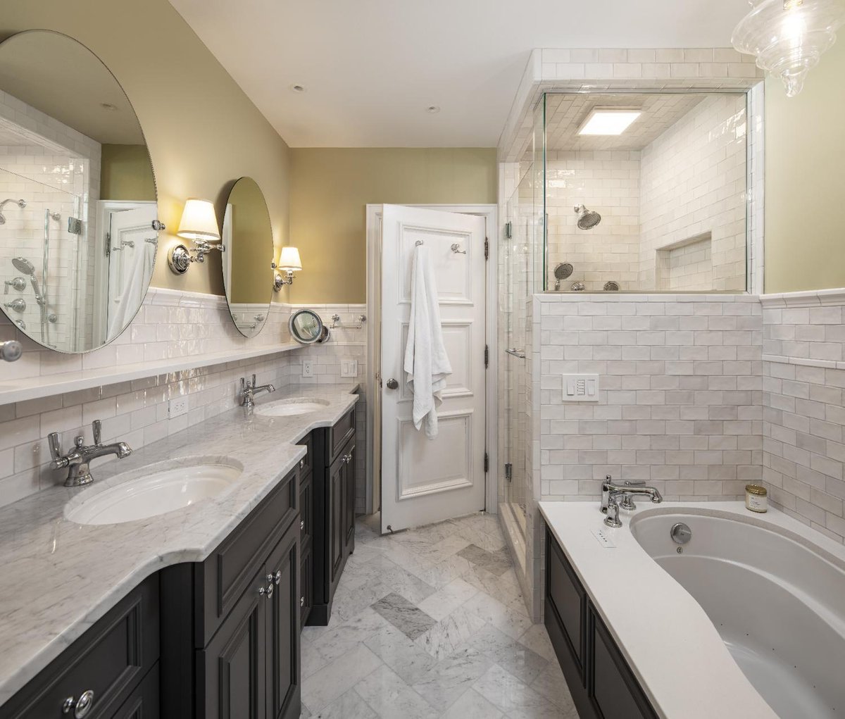 Luxury primary bath renovation in Omaha, NE by HC Remodel & Design featuring custom vanities, marble flooring, and a walk-in sho-optimized