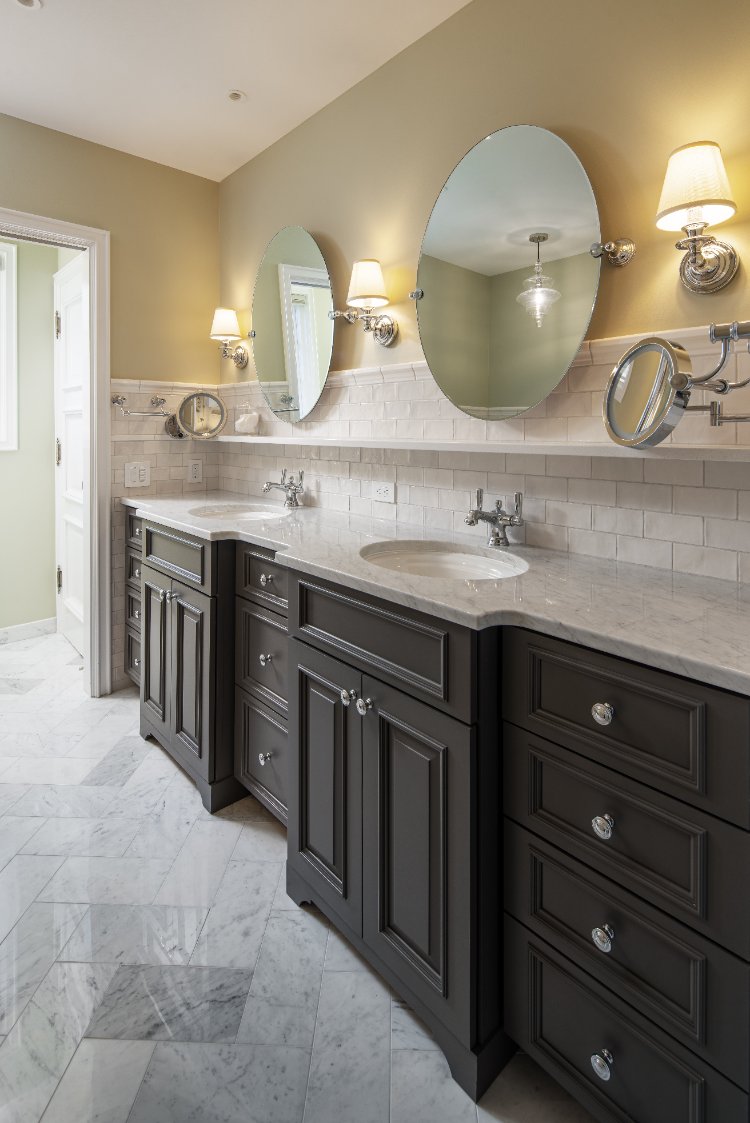 Primary bathroom remodel by HC Remodel & Design in Omaha, NE featuring a custom double vanity with marble countertops and oval m-optimized