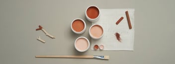 Image of different colors of paint and a paintbrush