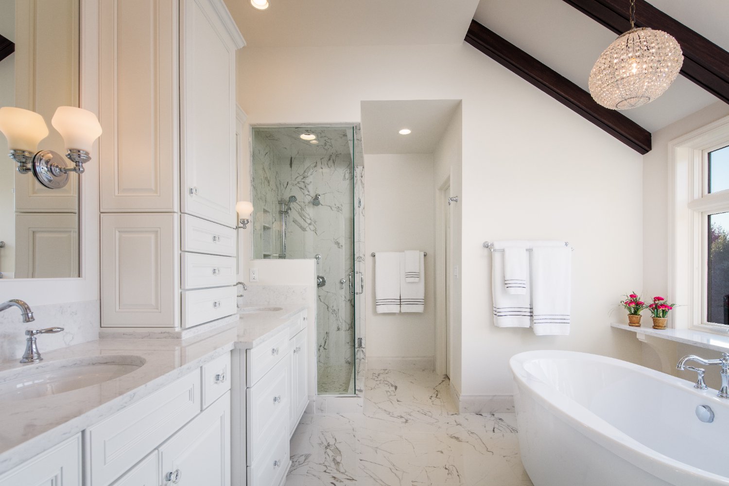 Master bathroom remodel by HC Remodel & Design in Omaha, NE with custom white cabinetry, a freestanding soaking tub, and marble -optimized