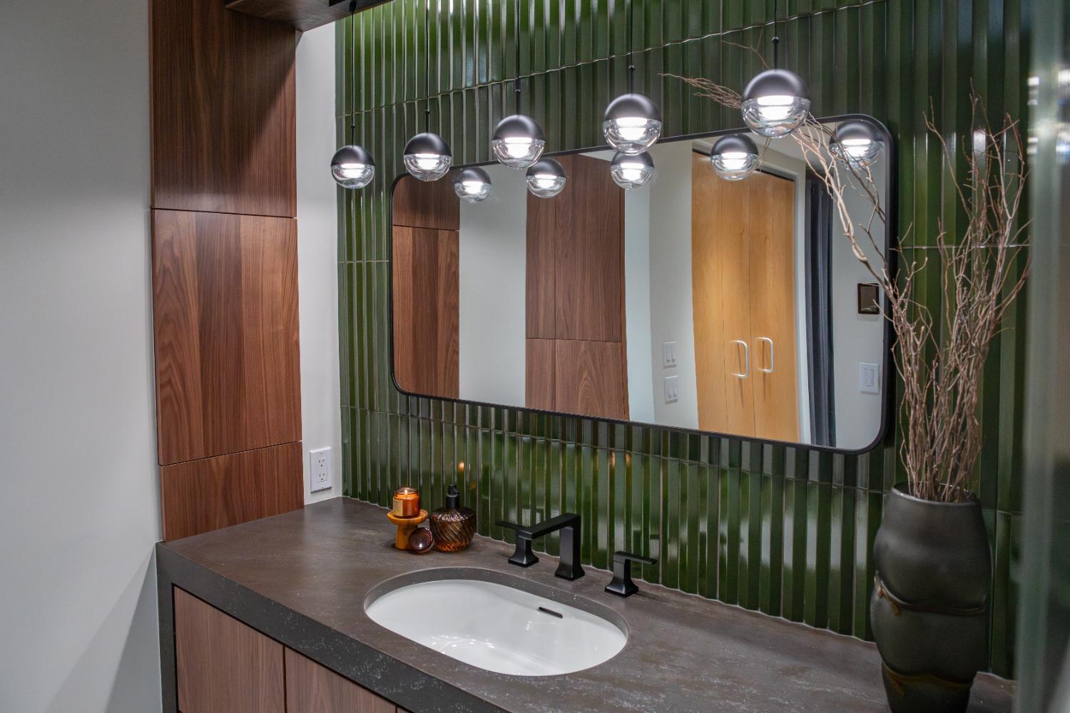 Contemporary bathroom vanity with oversized mirror and designer lighting in Omaha, NE by HC Remodel & Design.-optimized