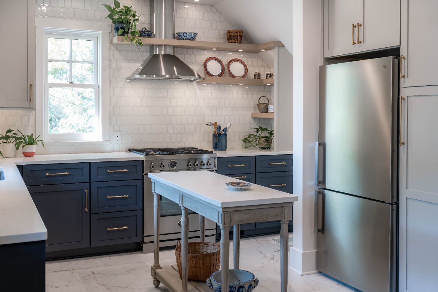 HC Remodel & Design kitchen remodel in Omaha, NE featuring a farmhouse-style prep island, blue cabinetry, and stainless steel re-optimized