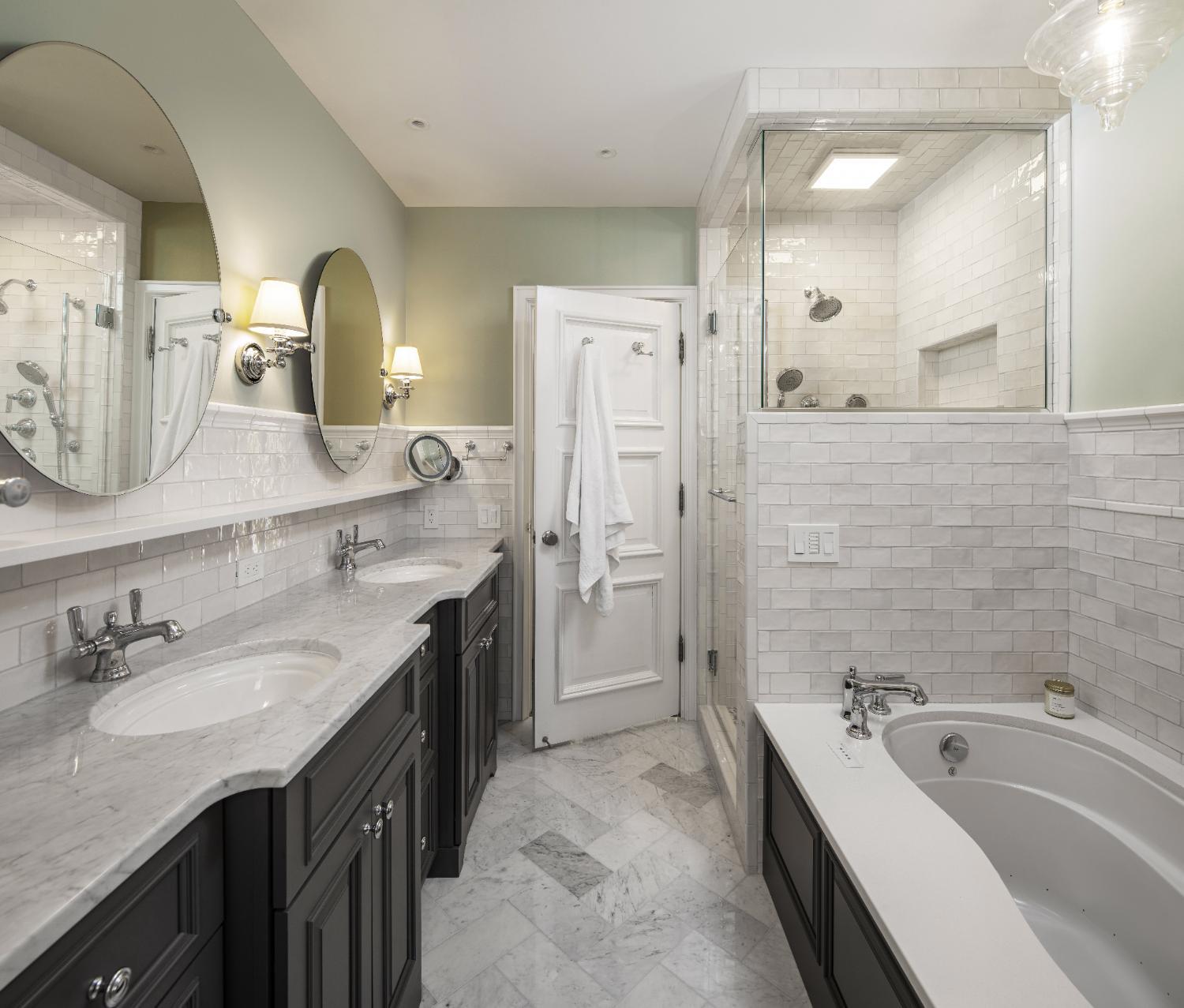 Primary bathroom remodel by HC Remodel & Design in Omaha, NE featuring a double vanity, freestanding soaking tub, and glass-encl-optimized