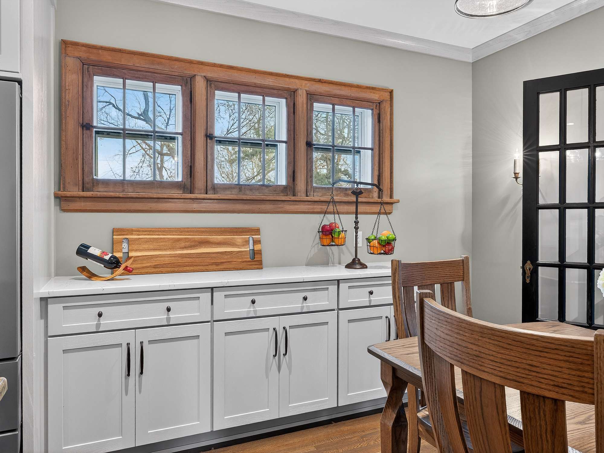 kitchen-buffet-gray-cabinets-quartz-counter-wood-trim-windows