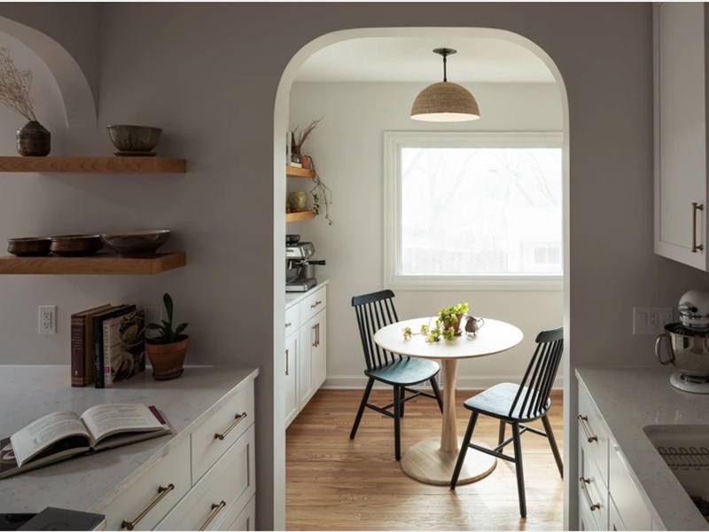 kitchen-island-arched-opening-breakfast-nook-pedestal-table