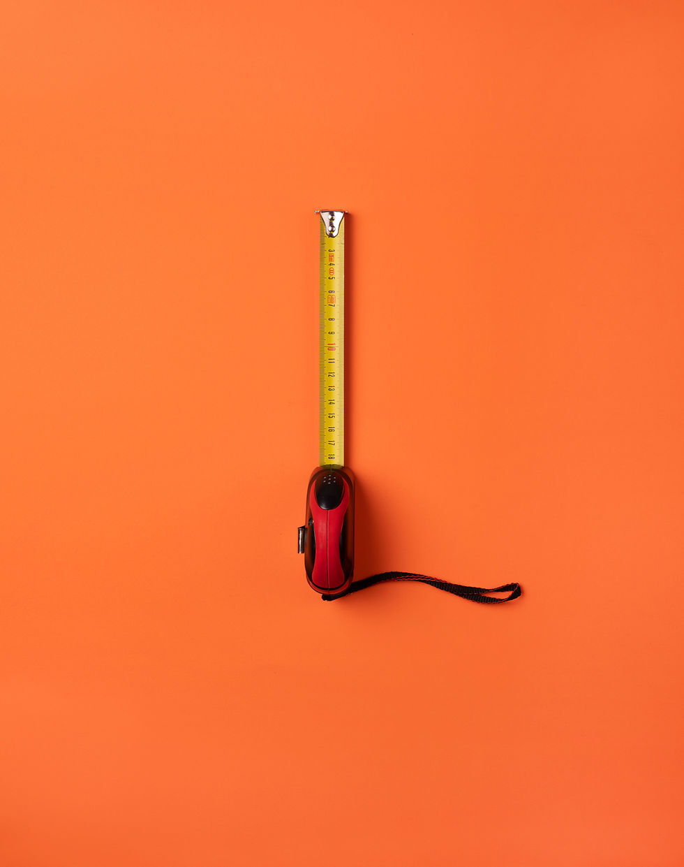 Image of a measuring tape over an orange background